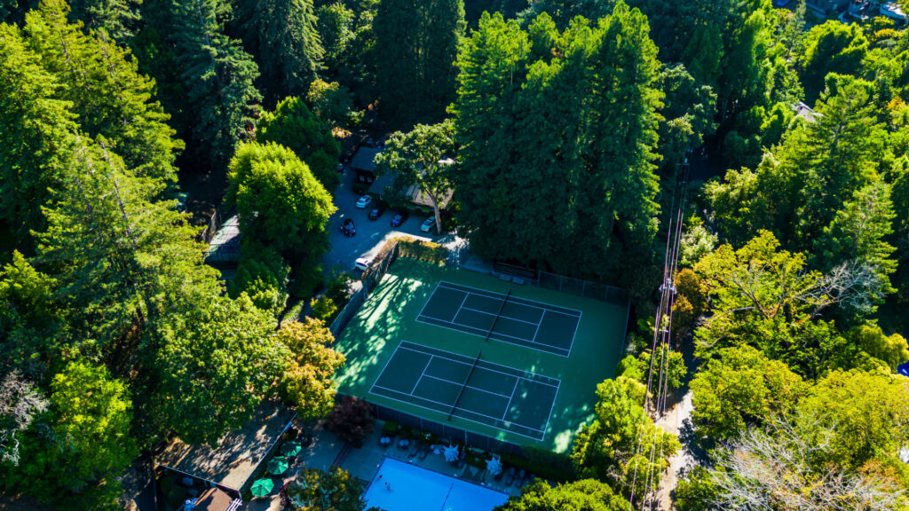 Two tennis courts at Lagunitas Country Club in Ross. The tennis courts were refurbished using the slipsheet overlay system and surfaced with Plexipave acrylic resurfacer in dark green and light green